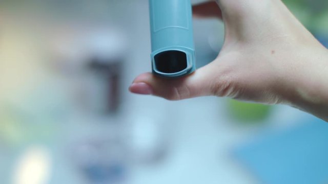 Push asthma inhaler. Close up of hand push asthma inhalant. Medical equipment asthma patient. Medical treatment for breath problems