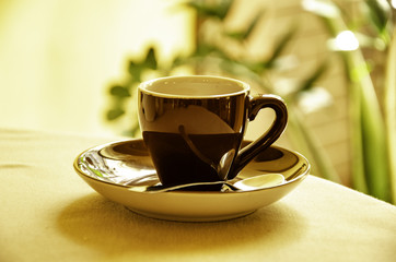 A cup of espresso on the coffee table in a cafe.