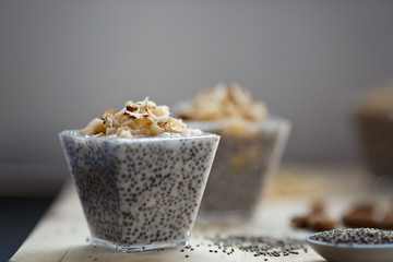 Chia pudding with mashed banana and sliced almonds, view from a side