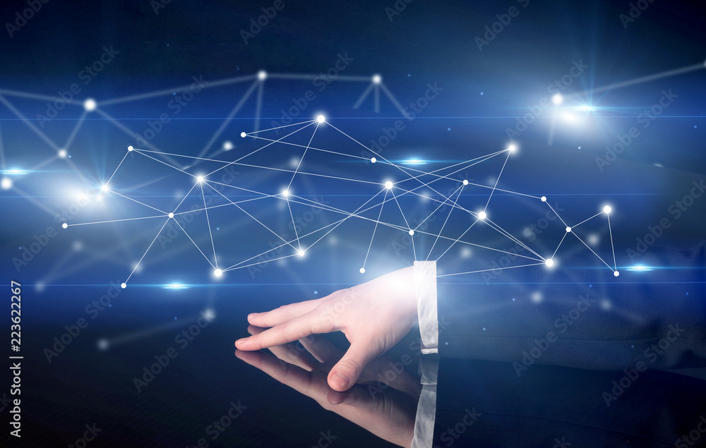 Poster male hands touching interactive table with blue connectivity graphic in the background