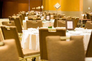 wedding table sets in wedding hall. wedding decorate preparation. table set and another catered event dinner, luxury wedding table setting for fine dining at indoors.