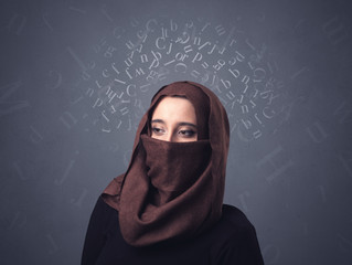 Young muslim woman wearing niqab with white alphabet letters above her head