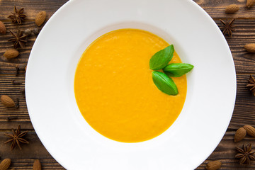 Tasty pumpkin cream soup with basil, potatoes and celery, blended with spice and onion.