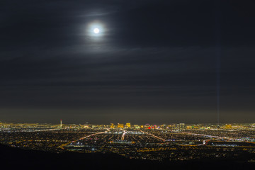Las Vegas Nevada full moon above cityscape skyline.  