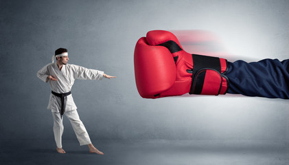 Little man fighting with a giant red boxing glove
