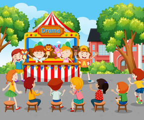 Obraz na płótnie Canvas Children watching puppet show outside