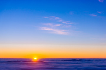 Amazing sunset over purple cloudy mountains
