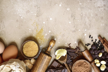 Ingredients for festive baking : flour, brown sugar, eggs, chocolate slices and drops, cocoa,...
