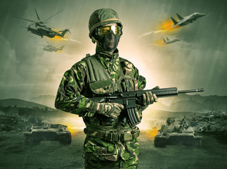 Armed soldier with sniper in the middle of a war
