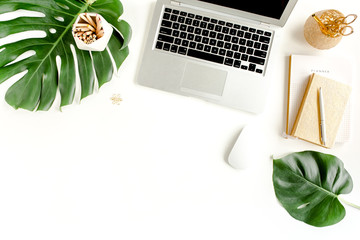 Stylized women's desk. Workspace with clipboard, tropical palm leaves Monstera, laptop, accessories...