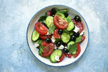 Vegetable salad with feta cheese and olive oil.Top view with copy space.