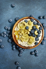 Oat porridge with fresh blueberry, banana and honey.Top view with copy space.