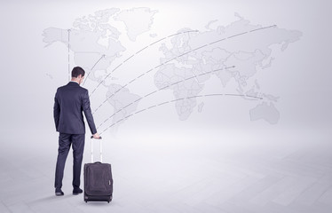 Businessman in dark suit planning his trip in a front of a map
