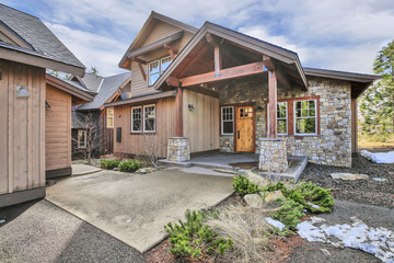 Beautiful home with wood and stone exterior, covered porch.