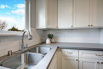 White and gray kitchen room with modern appliances.