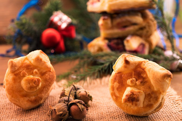 Symbol 2019-puff pastry pig on a linen napkin, vertical frame.
