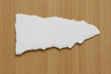 white torn paper texture on wood background, copy space.