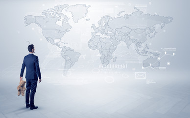 Businessman standing with his back and looking at a worldwide map with objects in his hand
