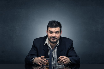 Young drunk man at his office with free dark copyspace