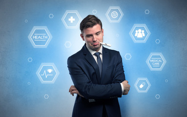 Young businessman with medical care, pills concept
