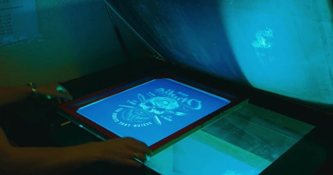 Silk screen printing process - forming a stencil from a screen with of a piece of mesh stretched over a frame. 4K UHD