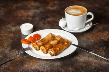 Crepes stuffed with cottage cheese and dried apricots