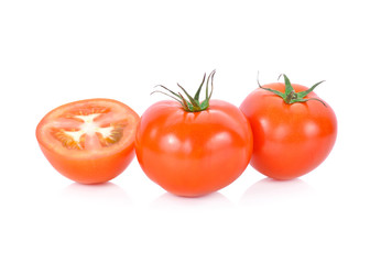 whole and half cut fresh tomato on white background