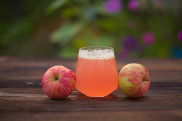 Delicious fresh squeezed apple juice in  transparent glass
