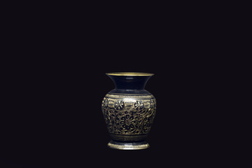 golden vase in a black background 