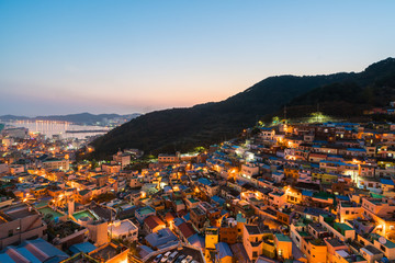 Gamcheon Culture Village formed by houses built in staircase-fashion on the foothills of a coastal mountain at night in Busan, South Korea.