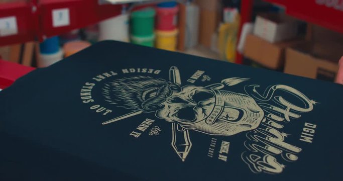 Silk screen printing process - making a print on a t-shirt. 4K UHD