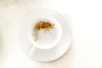 Obraz na płótnie Canvas Cup of coffee on a white background top view.