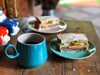 Healthy Breakfast with Homemade fresh sandwich and coffee cup on green plate set.