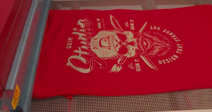 Silk screen printing process - making a print on a t-shirt. 4K UHD