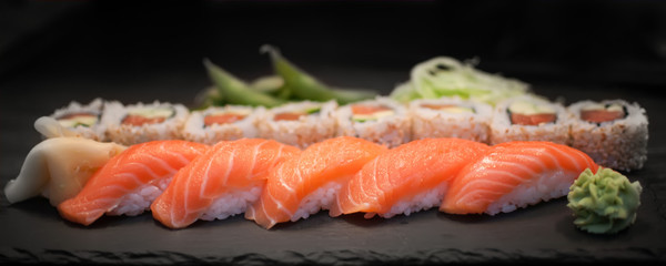Sushi nigiri and salmon avocado roll with seasame