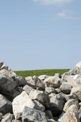 Heap of stones for raising the dike in the near future