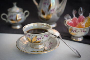 Still life with coffee in light porcelain on a dark background.