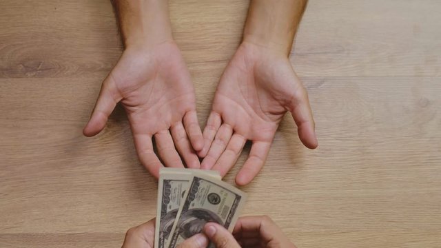 Picture of hands giving loaned money back
