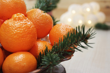 Mandarins and a ceramic plate.Close-up. Copy space.