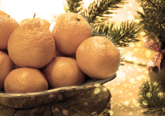 Decorative composition with tangerines. The concept of Christmas holidays.Image in sepia tones.