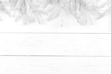 Christmas composition. Frame made of fir branches on white wooden background. Christmas, winter concept. Flat lay, top view, copy space