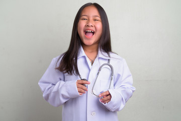 Portrait of young cute Asian girl as doctor