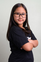 Young cute Asian nerd girl wearing eyeglasses