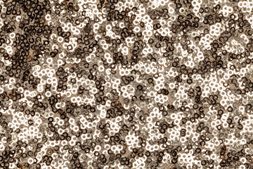 Sparkling background of golden sparkles closeup.