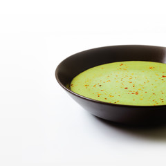 Split pea soup in an old bowl on a white background