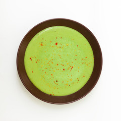 Split pea soup in an old bowl on a white background