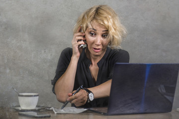 lifestyle portrait of young stressed and messy business woman working at office laptop computer...