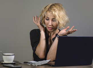 lifestyle portrait of young stressed and messy business woman working at office laptop computer...