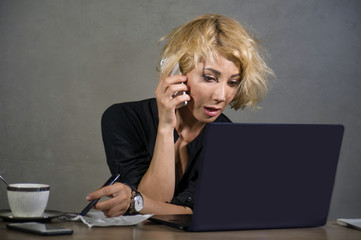 lifestyle portrait of young stressed and messy business woman working at office laptop computer...