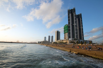 Sunset over cityscape skyline at the Galle Face beachfront urban park area in Colombo Sri Lanka Asia